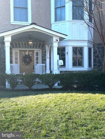 a view of a house with yard and trees in the background