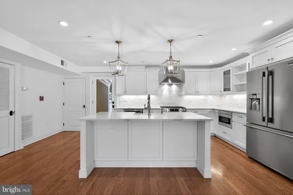 a kitchen with granite countertop a sink appliances and cabinets