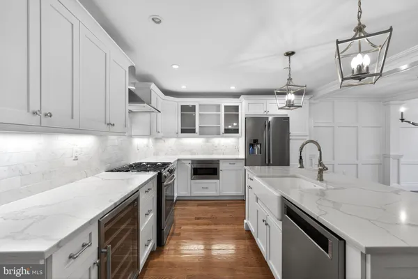 a kitchen with kitchen island granite countertop a stove and a sink