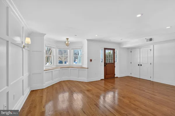 a view of empty room with wooden floor and windows