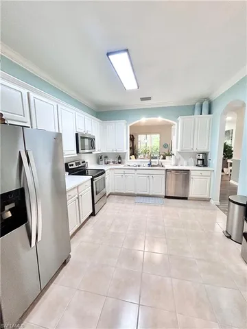 a kitchen with granite countertop a sink stainless steel appliances and cabinets