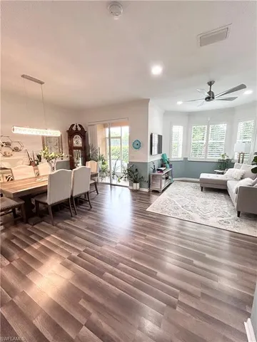 a living room with lots of furniture wooden floor and rug