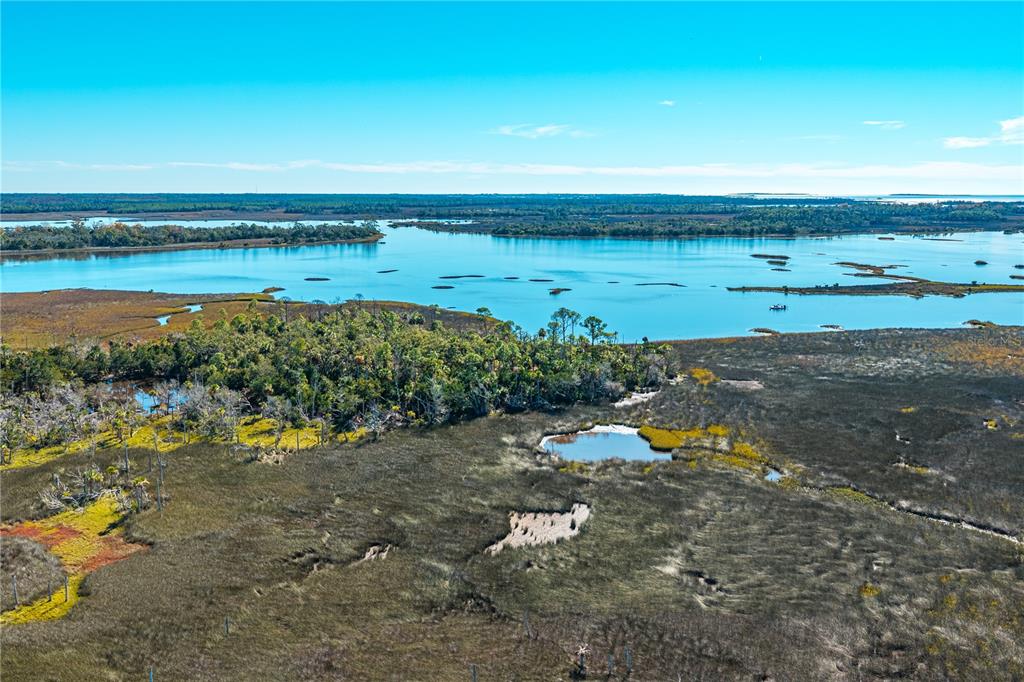 Clark Island Cedar Key, FL 32625 - Photo 19 of 46 an aerial view of beach and residential houses with outdoor space