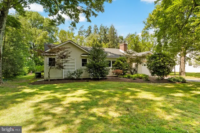 a view of a fountain in front of a house with a big yard