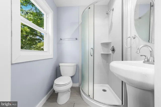a bathroom with a toilet a sink and a mirror