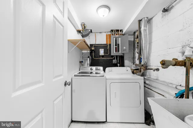 a view of storage and utility room with washer and dryer