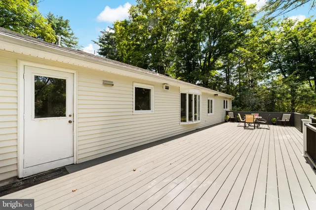 a balcony with wooden floor and fence