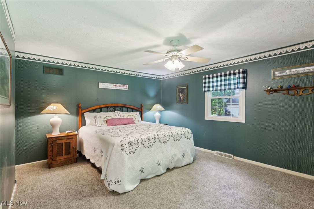 5568 Forest Glen Road Madison, OH 44057 - Photo 26 of 50 Carpeted bedroom with a textured ceiling and a ceiling fan