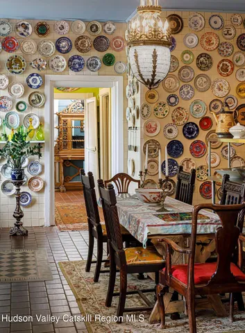 a view of a dining room with furniture and a potted plant