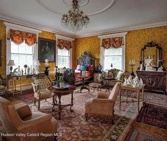 a living room with furniture a large window and a chandelier