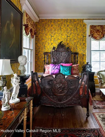 a living room with a couch and a potted plant
