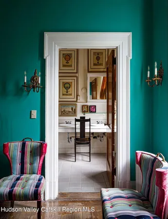 a living room with furniture and painting on the wall