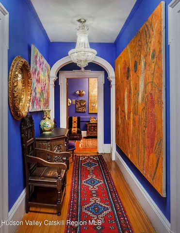 a living room with a furniture a rug and a window