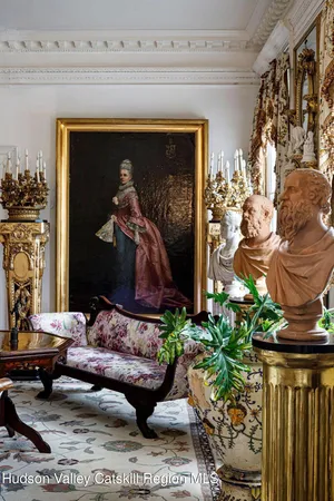 a living room with furniture and flowers