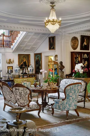 a living room with furniture and a chandelier