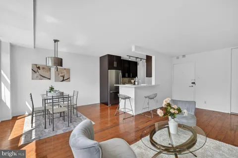 a living room with furniture and a wooden floor