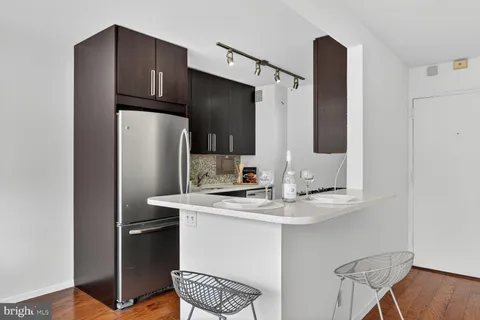 a kitchen with stainless steel appliances a refrigerator and a sink