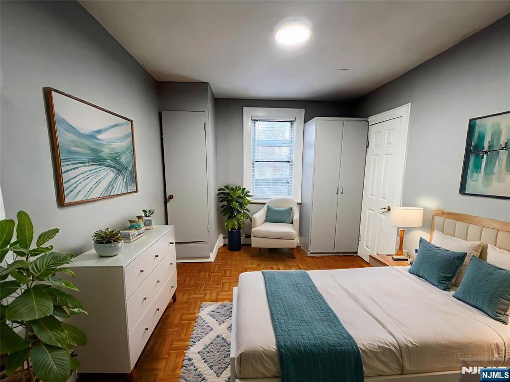 419 Plainfield Avenue Berkeley Heights, NJ 07922 - Photo 6 of 9 a bedroom with a bed table and a potted plant