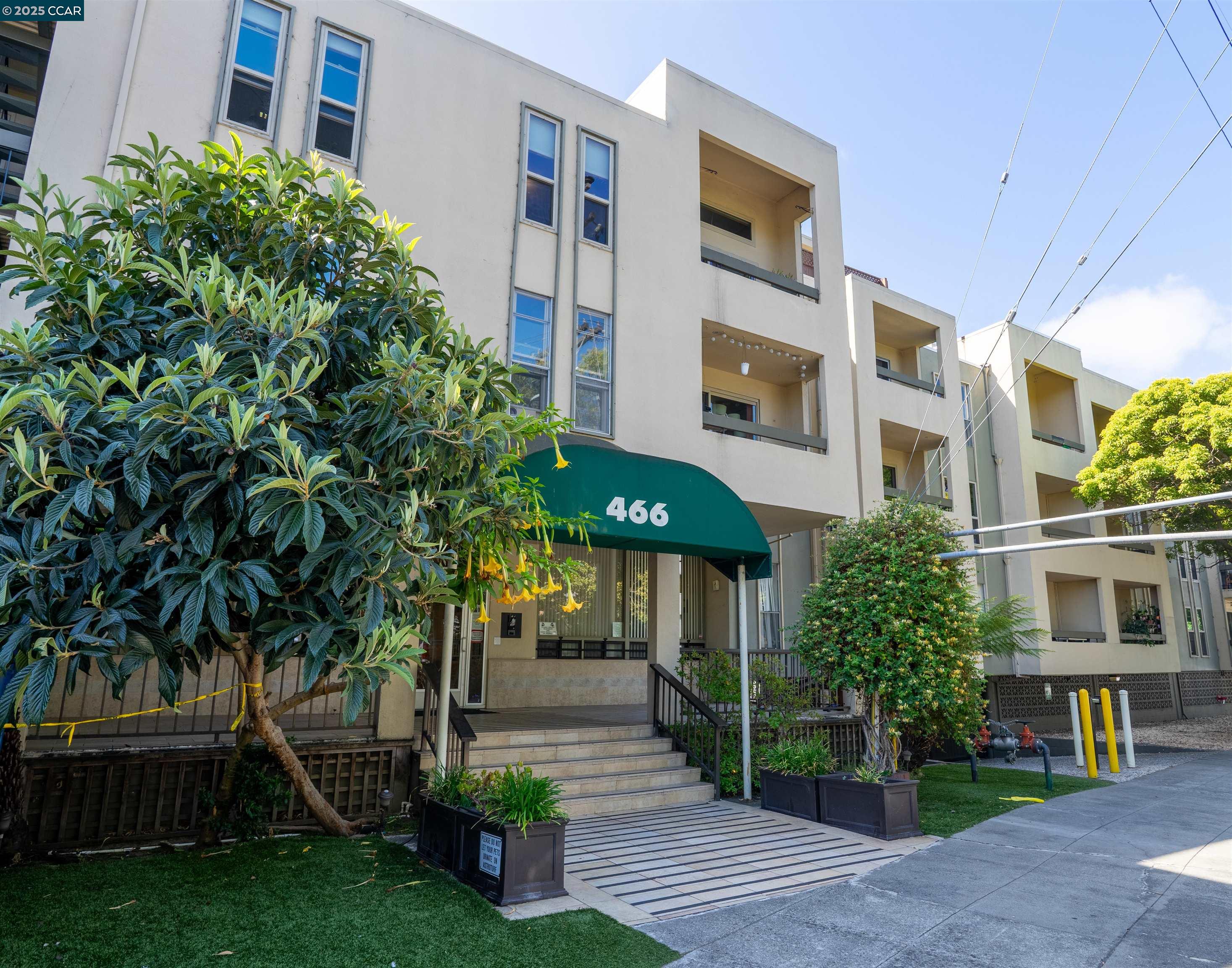 466 Crescent Street, Unit 306 Oakland, CA 94610 - Photo 26 of 26 a front view of a building with a garden