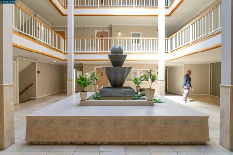 a view of a hallway with wooden shelves