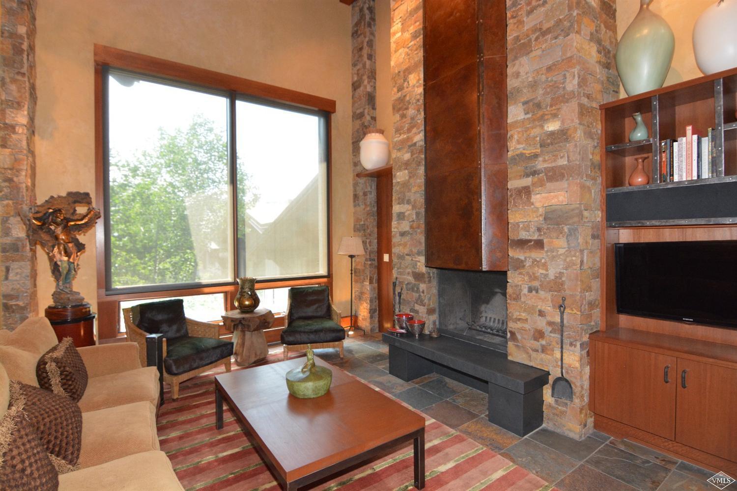 a living room with fireplace furniture and a flat screen tv