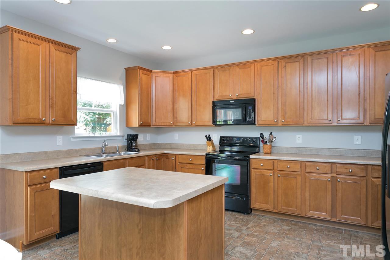118 Key Biscayne Court Raleigh, NC 27603 - Photo 14 of 30 a kitchen with stainless steel appliances granite countertop a sink stove microwave and refrigerator