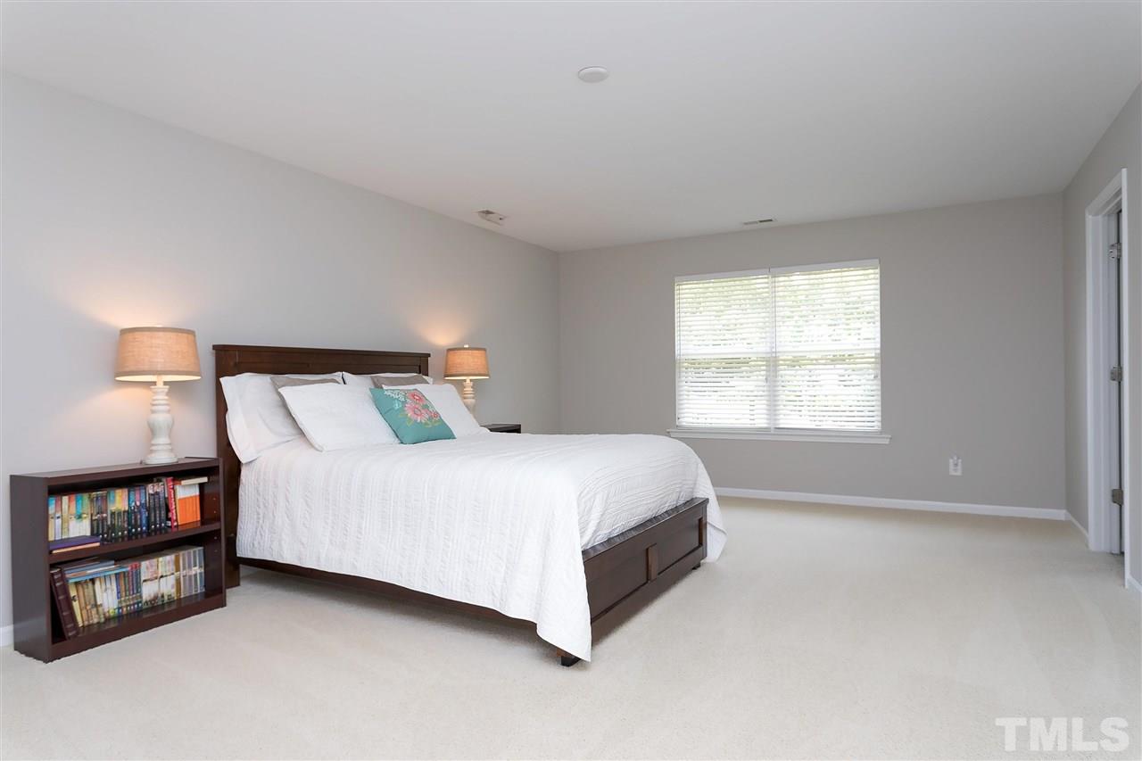 118 Key Biscayne Court Raleigh, NC 27603 - Photo 20 of 30 a bed sitting in a bedroom next to a window