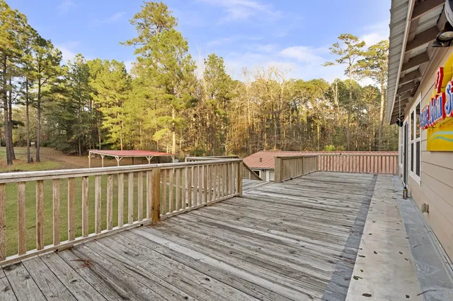 a view of a balcony with wooden floor and fence