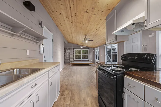 a kitchen that has a sink and a stove