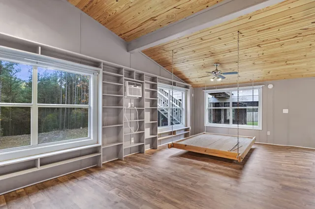 a view of a room with wooden floor and windows