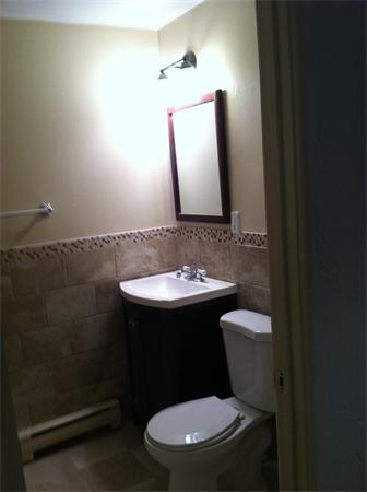 288 Swanson Road, Unit 203 Boxborough, MA 01719 - Photo 3 of 3 a bathroom with a toilet sink and mirror