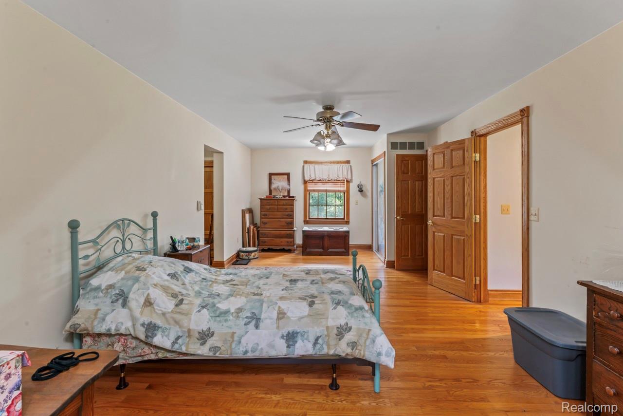 1591 Baldwin Road Lapeer, MI 48446 - Photo 21 of 46 Bedroom with a closet, light wood-style flooring, and a ceiling fan
