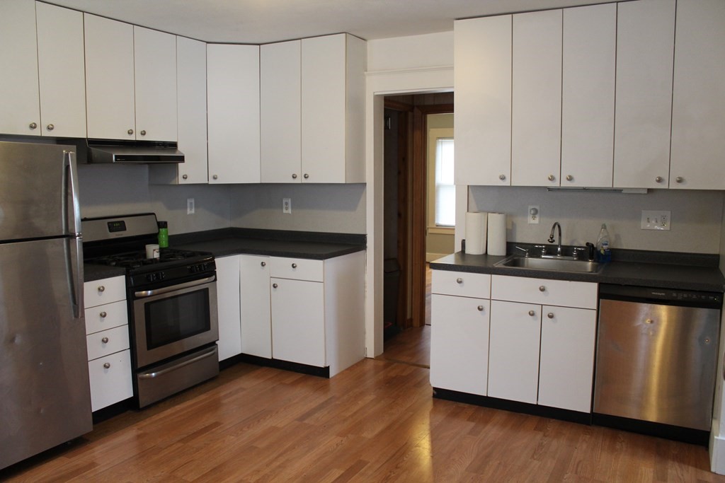 14 Richelieu Street Chicopee, MA 01020 - Photo 2 of 16 a kitchen with granite countertop white cabinets and white appliances
