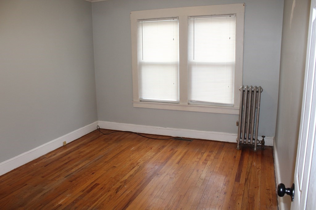 14 Richelieu Street Chicopee, MA 01020 - Photo 6 of 16 an empty room with wooden floor and windows