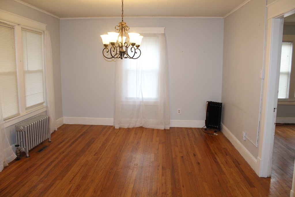 14 Richelieu Street Chicopee, MA 01020 - Photo 7 of 16 wooden floor in an empty room with a window