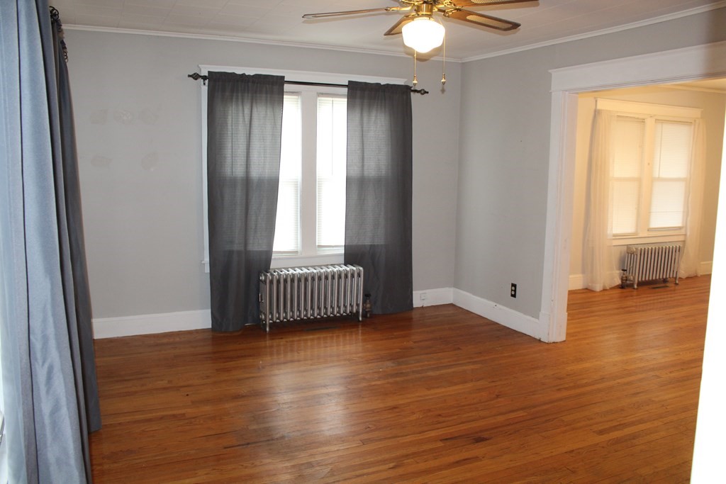 14 Richelieu Street Chicopee, MA 01020 - Photo 9 of 16 a view of an empty room with wooden floor and a window