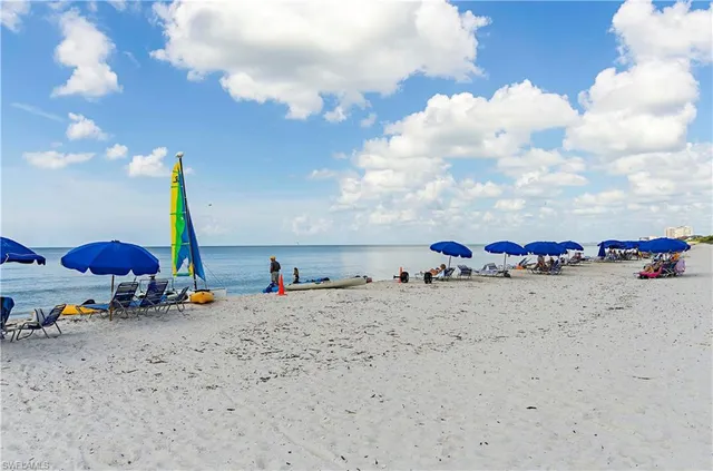a living room with lots of furniture and a chandelier