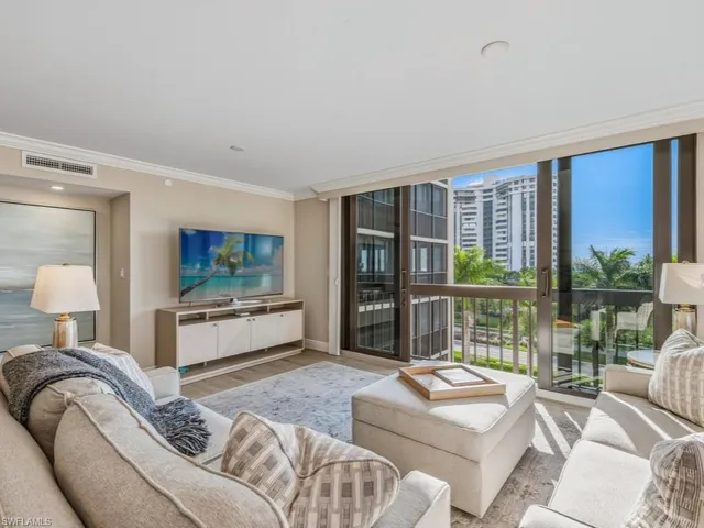 a bedroom with furniture and large windows