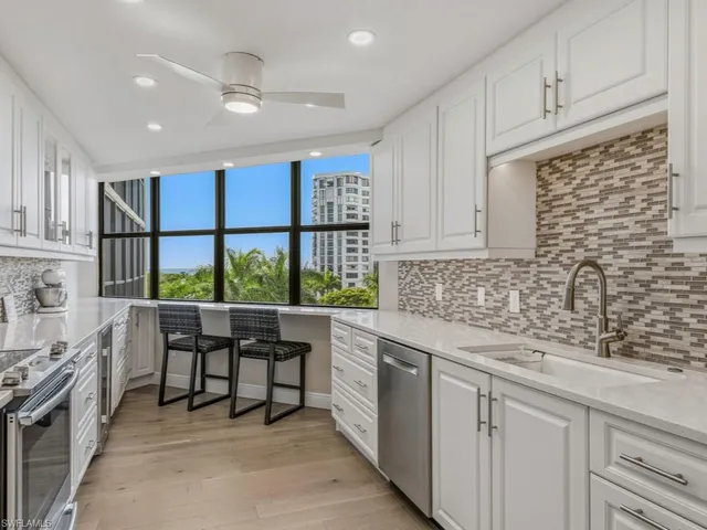 a kitchen with stainless steel appliances granite countertop a sink and cabinets