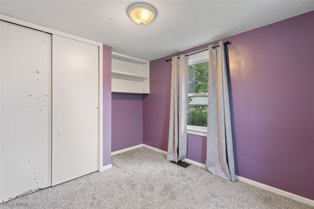 1853 Sylvan Road Wooster, OH 44691 - Photo 17 of 37 Unfurnished bedroom with carpet floors, a closet, and a textured ceiling