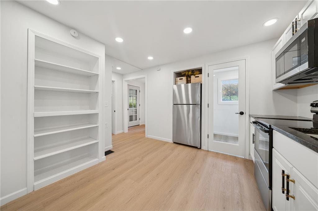 624 6th Street Mather, PA 15346 - Photo 12 of 26 a view of a kitchen with a refrigerator and a stove top oven