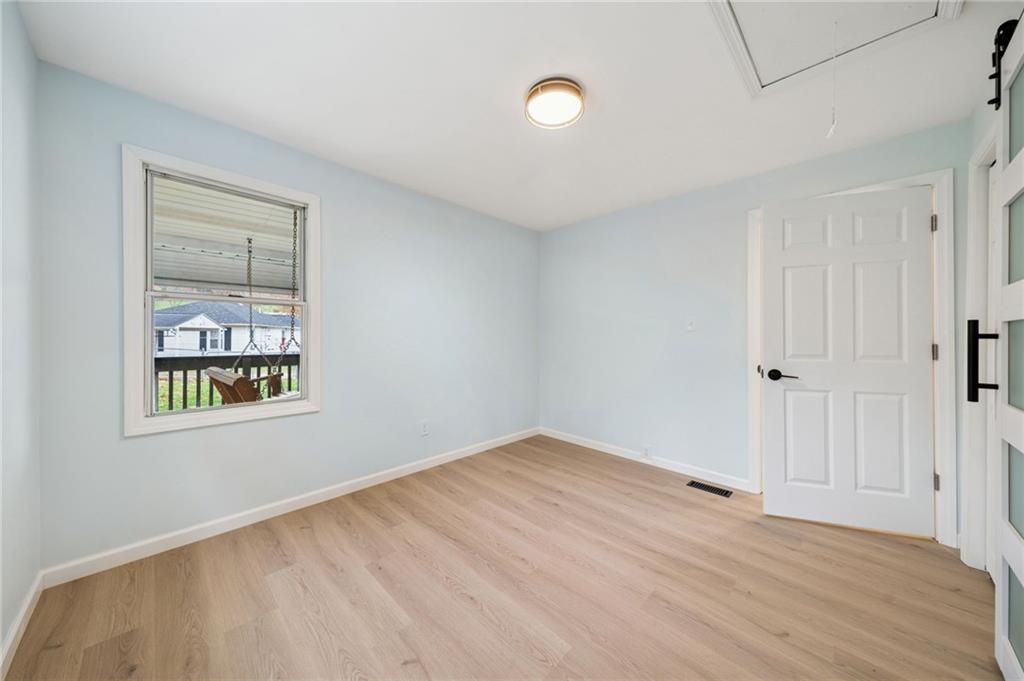 624 6th Street Mather, PA 15346 - Photo 19 of 26 a view of an empty room with wooden floor and a window