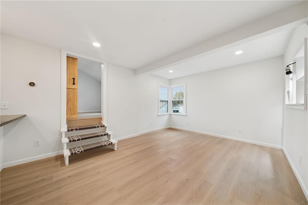 624 6th Street Mather, PA 15346 - Photo 9 of 26 an empty room with wooden floor and white walls