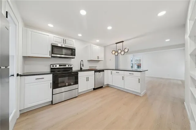 a kitchen with cabinets stainless steel appliances and a counter top space