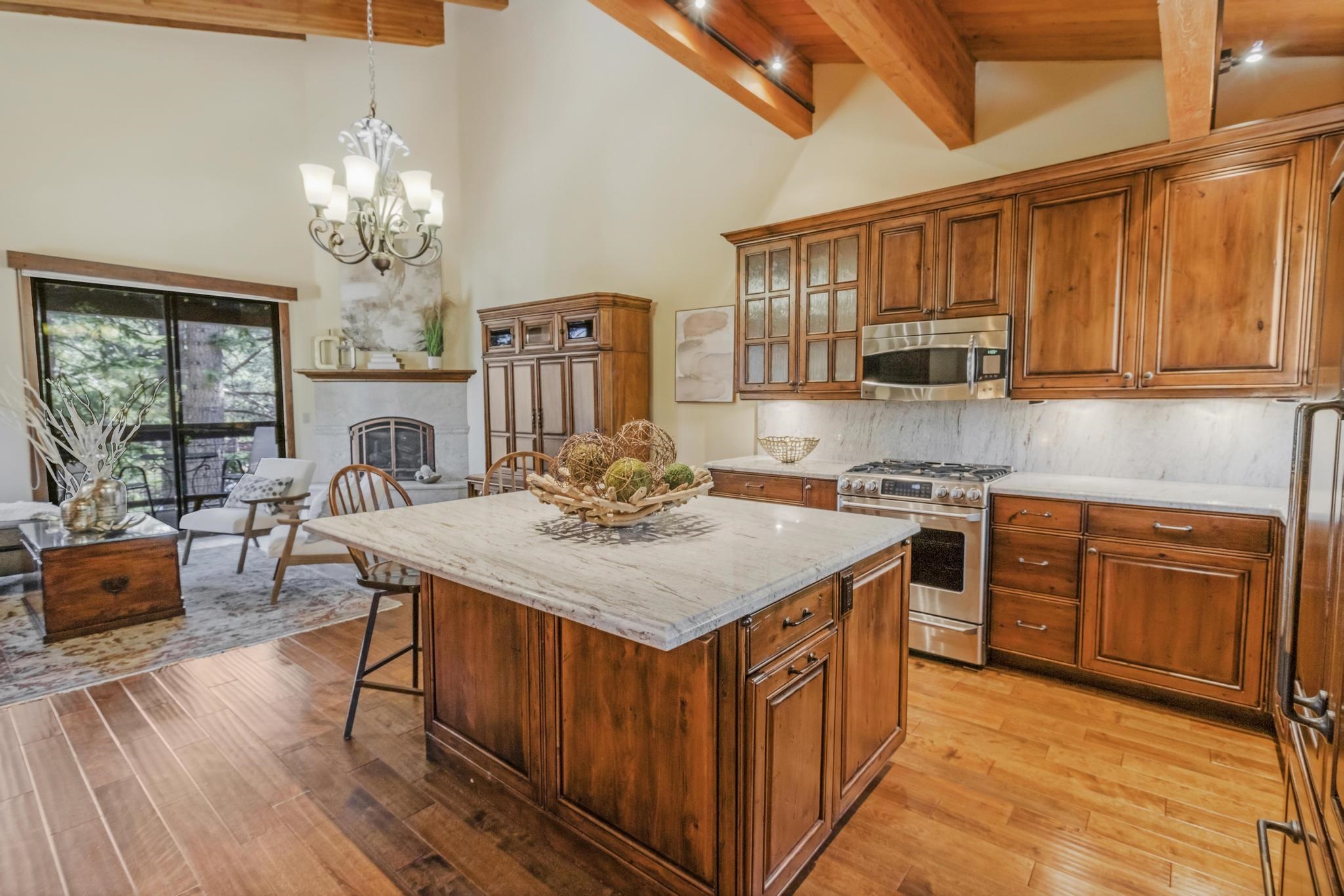 3035 Silver Strike Truckee, CA 96161 - Photo 3 of 20 a kitchen with stainless steel appliances granite countertop a stove a sink dishwasher and a refrigerator with wooden floor