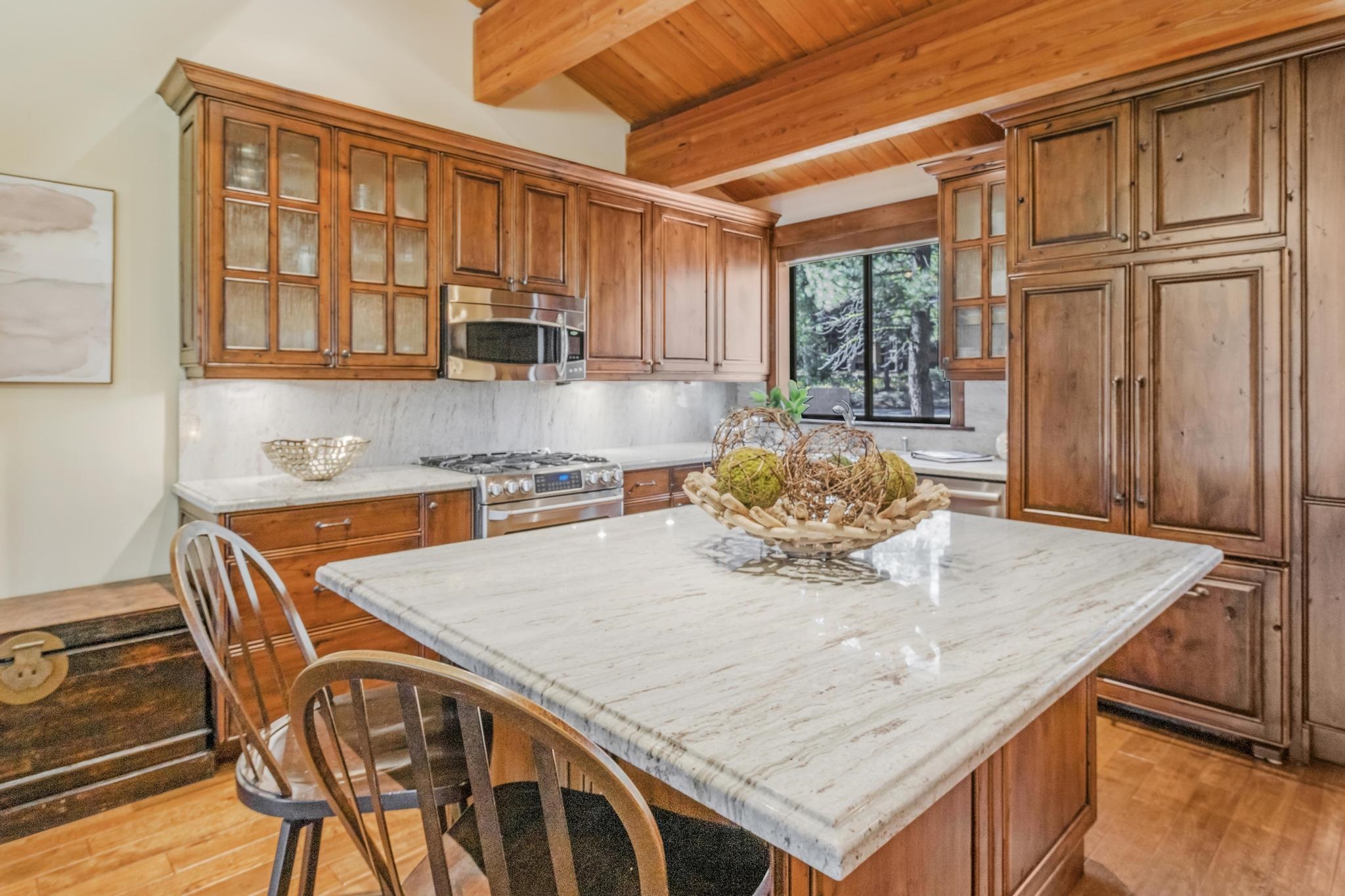 3035 Silver Strike Truckee, CA 96161 - Photo 4 of 20 a kitchen with stainless steel appliances granite countertop a stove a sink and a microwave