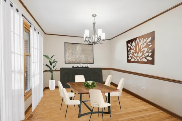 a view of a dining room with furniture a chandelier and wooden floor