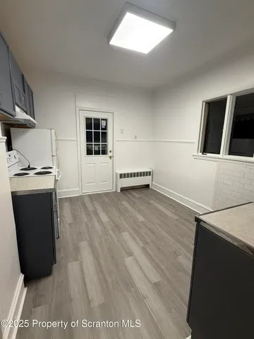 a view of kitchen with stainless steel appliances a refrigerator and a stove