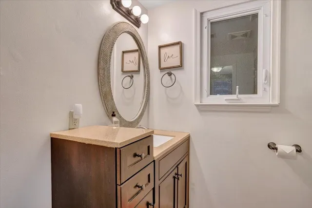 a front view of a house with a yard covered in snow