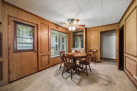 a view of a dining room with furniture and a window